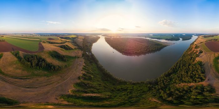 Aerial drone view of river landscape in sunny summer evening. Top view of siberian Ob river from high attitude in summer sunset. Panorama, bird's eye view