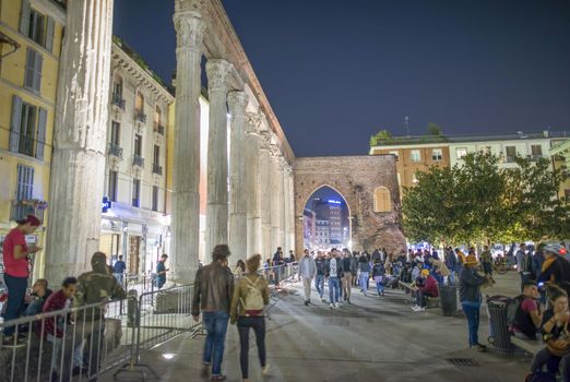 MILAN, ITALY - SEPTEMBER 2015: Tourists and locals enjoy night life near San Lorenzo Columns.