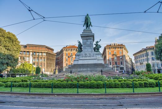 MILAN, ITALY - SEPTEMBER 2015: Tourists on square Largo Cairoli near Monument to Giuseppe Garibaldi in Milan.