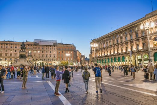 MILAN, ITALY - SEPTEMBER 2015: Tourists and locals enjoy night life in Duomo Square, city tourist center