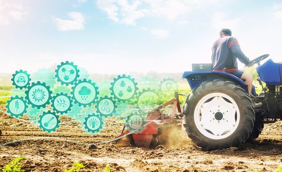 Farmer on a tractor cultivates a farm field and technological innovation gears hologram. Science of agronomy. Farming and agriculture startups. Improving efficiency. Soil milling, crumbling and mixing