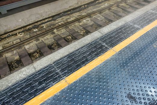 Subway station with yellow line, metro interior.