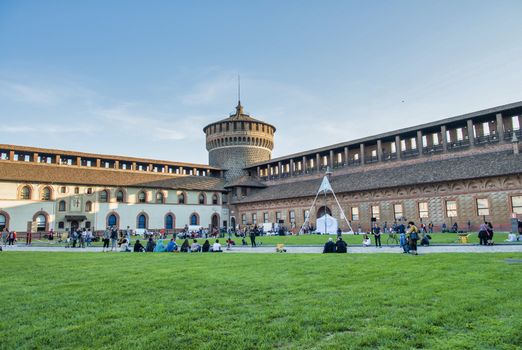 MILAN, ITALY - SEPTEMBER 2015: Tourists visit Sforza Castle and Park in summer season.