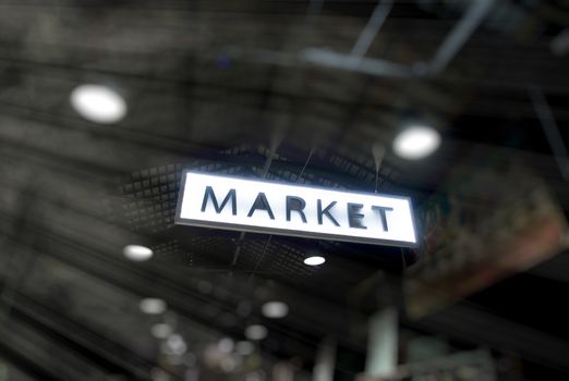 Night market, entrance sign with light rays.