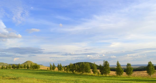 summer landscape with mountain and blue sky with clouds