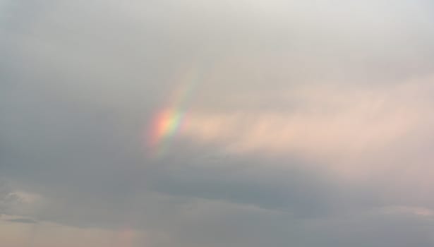Beautiful eveing sky with clouds and rainbow, air nature 