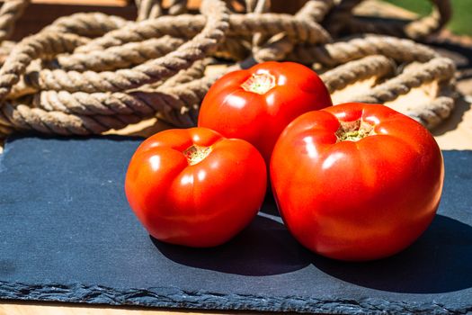 Close up of fresh ripe tomatoes isolated in a rustic composition,