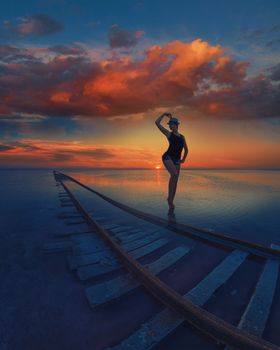 Woman at beauty sunset on salty lake