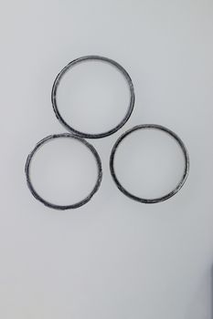 Three platinum round rings on white background