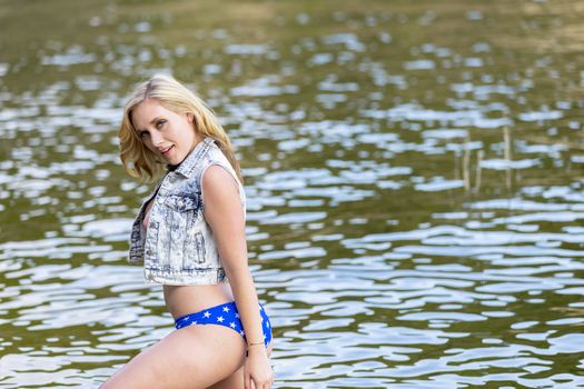 A gorgeous blonde model enjoys the lake on a summers day