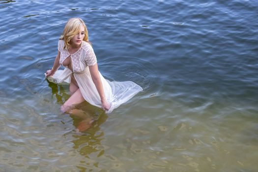 A gorgeous blonde model enjoys the lake on a summers day