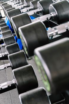 Close up image of Fitness equipment dumbbells weight,Gym background