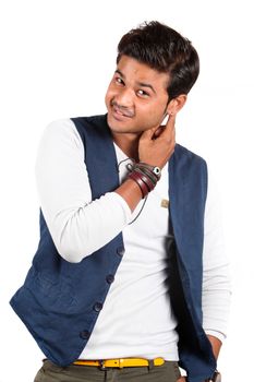 A handsome young Indian guy smiling, on white studio background.