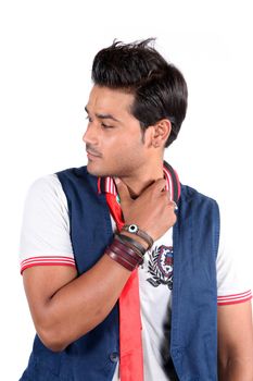 A handsome young Indian guy lost in his thoughts, on white studio background.