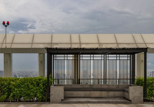 Relaxing furnished area on rooftop in warm summer day with the background of blue sky. Resting area.