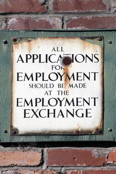 Old vintage retro distressed enamel metal application for employment sign stock photo