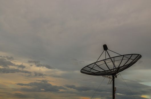 Black Satellite Dish Antenna Receiver Against on Blue Sky background for Communication and Media Industry, Symbolizing Global Communications. Free copy space for text, Selective focus.