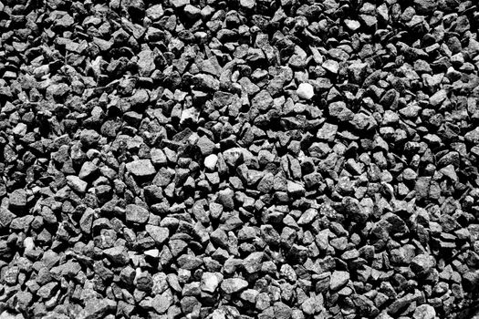 Background texture of crushed quarry rock pebble stones used for landscaping black and white monochrome image stock photo