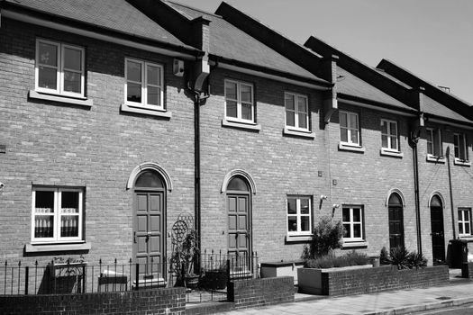 Modern new terraced houses in Docklands London England UK black and white monochrome image stock photo