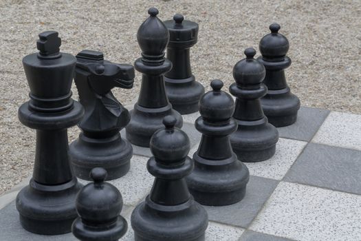 Black and white king on a chess board in open air