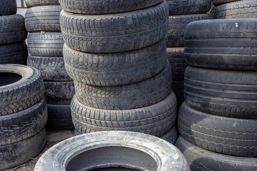 old used small car tires stacks full frame background.