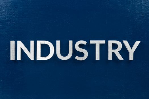 the word industry laid weith white letters over blue flat background in center of picture with directly above perspective