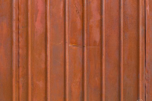 flat fluted matte brown painted steel surface with light rust spots and minor scratches