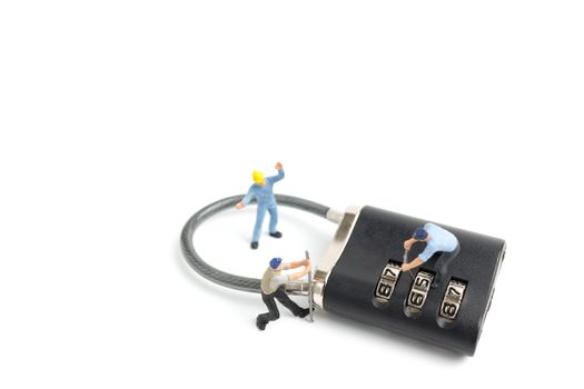 Miniature people worker  : Teamwork helps to unlock password on the keys. Team work concept.