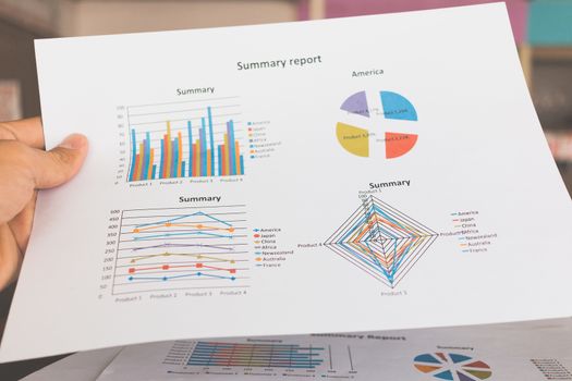 Financial graphs and charts on wooden table