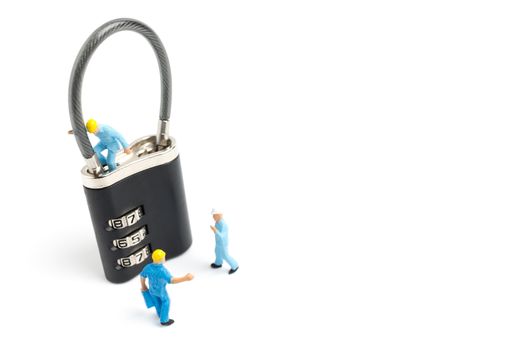 Miniature people worker  : Teamwork helps to unlock password on the keys. Team work concept.