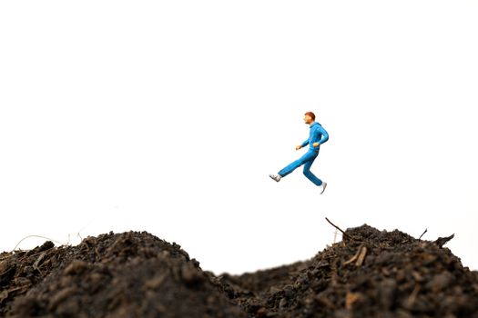 Miniature people : Man Running on The ground  isolated on white background , Run for health concept.