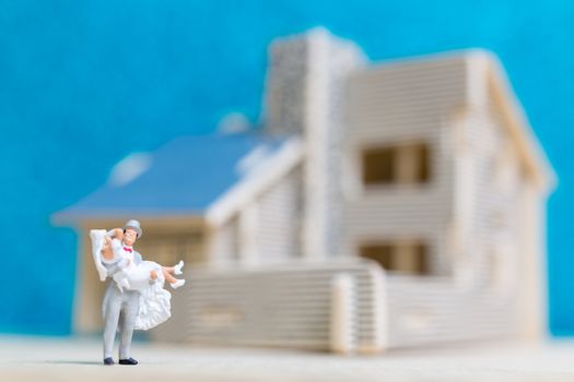 Miniature people : Bride and groom , Couple  on blue background.