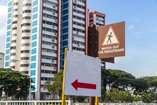 Lots of crazy brown and white empty street signs and information signs in Singapore.