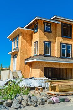 Brand new townhouses building under construction on sunny day in British Columbia, Canada.