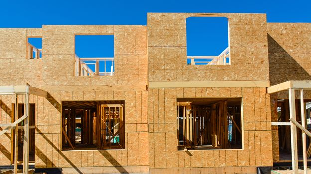 Window frame of new low rise building on blue sky background