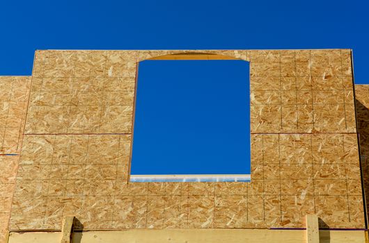 Window frame of new low rise building on blue sky background