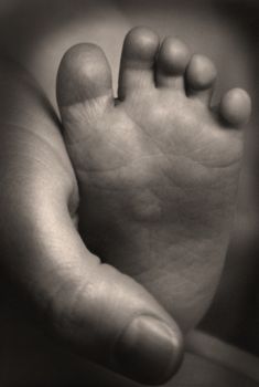 Infant foot in mother's hand