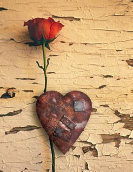 Surrealism. Red love rose and rusted heart with metal patches.