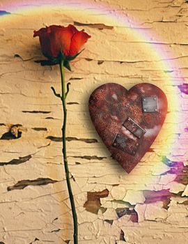 Surrealism. Red rose and rusted heart with metal patches. Rainbow.