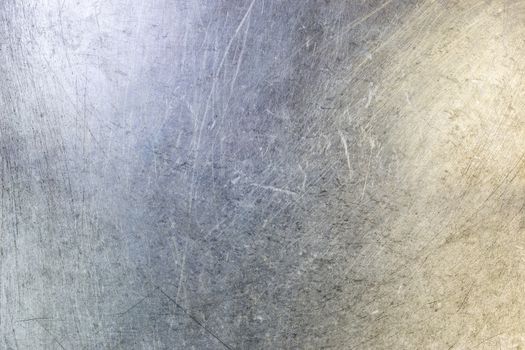 scratched flat stainless steel sheet surface background and texture with light and color gradients