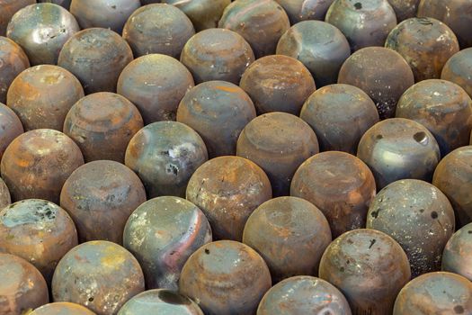 abstract full frame industrial background of rusted steel dome round workpieces after thick sheet steel draw process