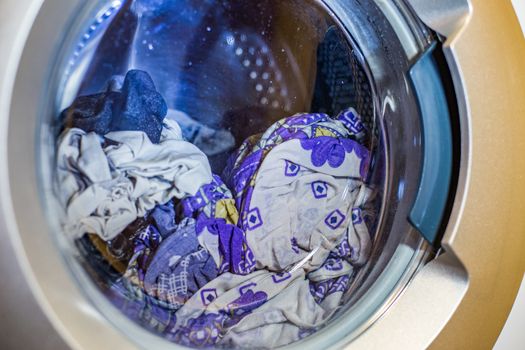 a close view of domestic washing machine at work.