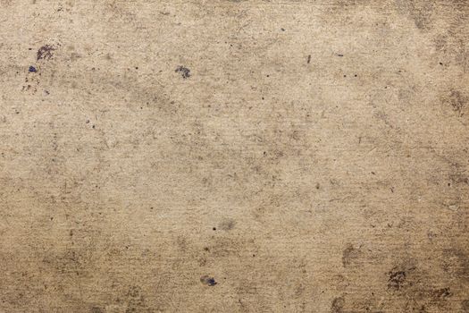 dirty flat cardboard surface texture and background with black spots of oil and technical pollutions.