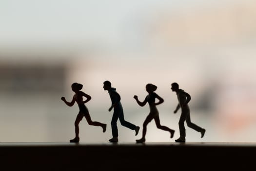 Miniature people is Running , Silhouette of a runner , Health And lifestyle concepts.