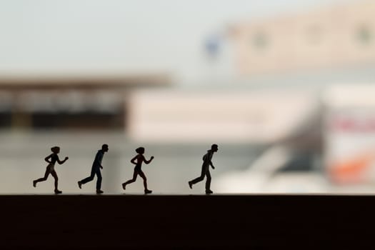 Miniature people is Running , Silhouette of a runner , Health And lifestyle concepts.