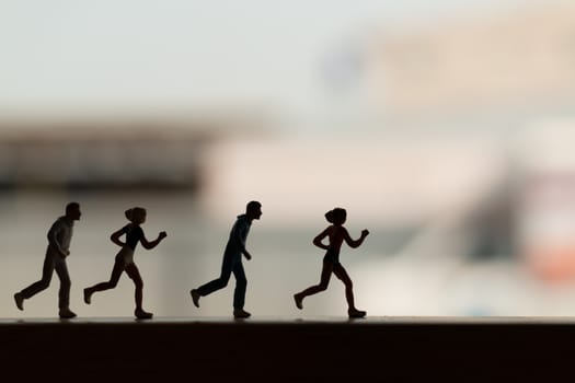 Miniature people is Running , Silhouette of a runner , Health And lifestyle concepts.