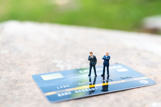 Miniature people : business people sianding on Credit card , Business and Finance concepts