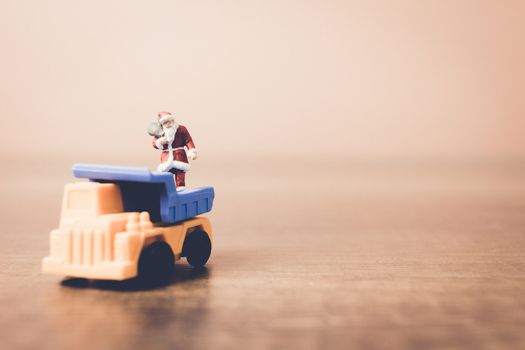 Miniature people Santa Claus carrying bag , Christmas celebration concept.