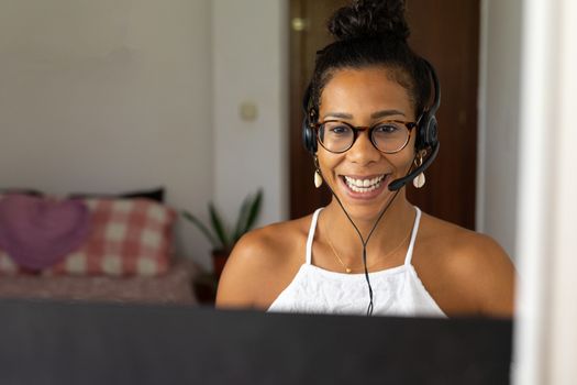 Working brazilian young woman in bedroom. Telemeeting. Video conference. Remote work. Call center home.