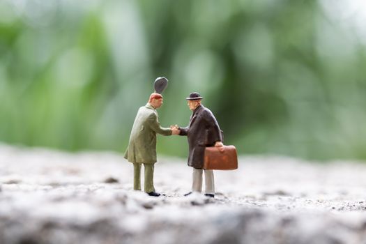 Miniature people : Business people meeting greeting shaking hands outdoor scene , Connecting People concept